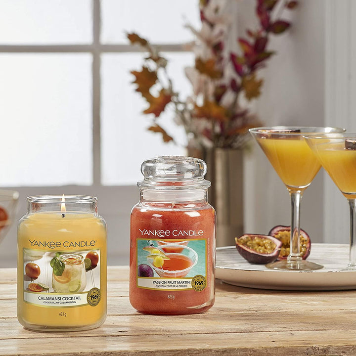 An image showcasing a Yankee Candle jar in the Passion Fruit Martini scent, with a burn time of up to 150 hours.