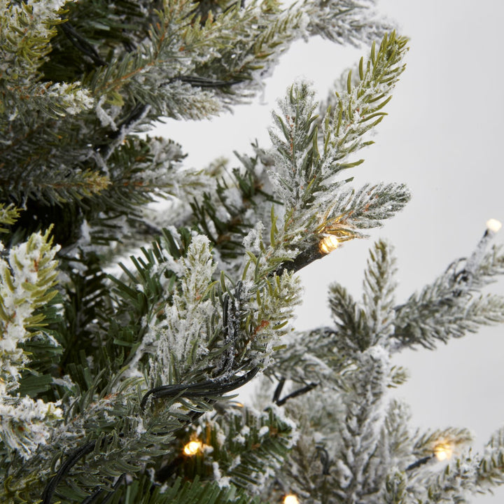 A 6ft snowy spruce Christmas tree, perfect for creating festive holiday decor.