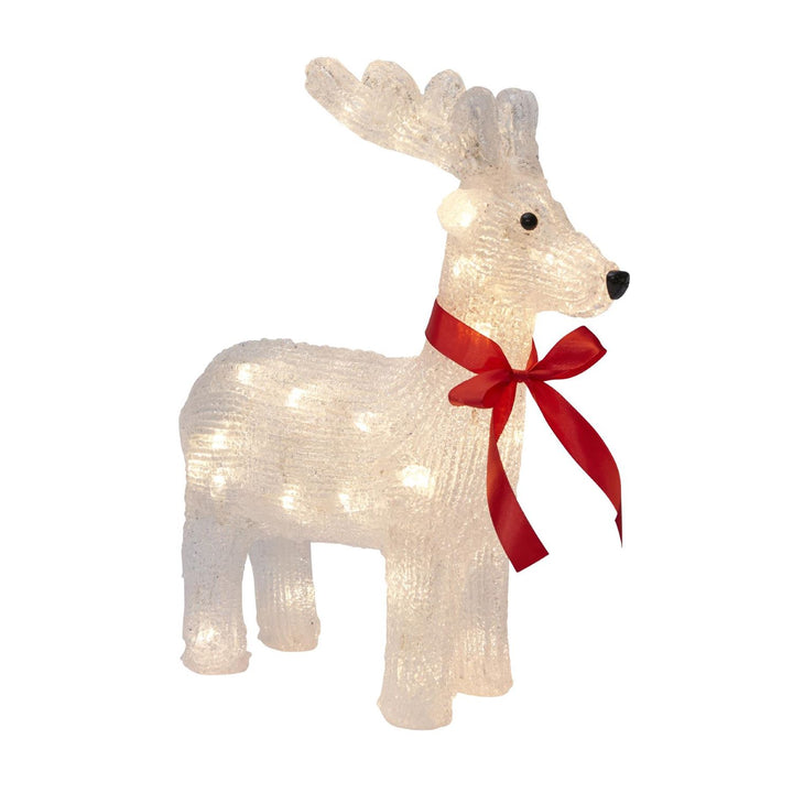 Acrylic reindeer figurine in a winter wonderland setting.