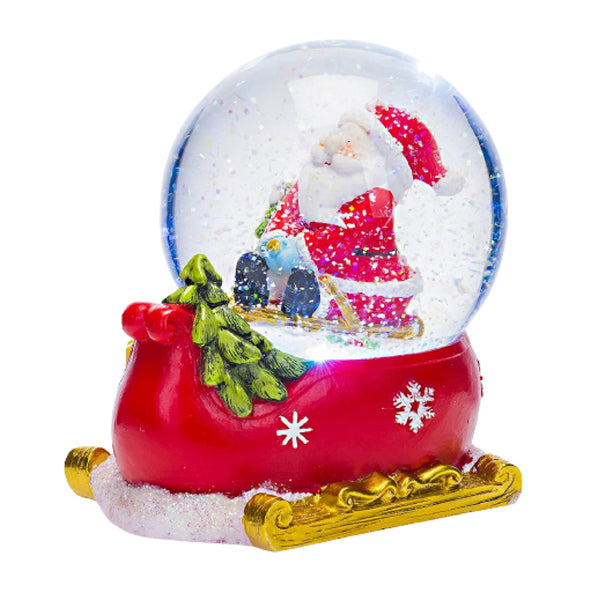 This charming snow globe captures the magic of Christmas with Santa and a child sledging, accompanied by music.