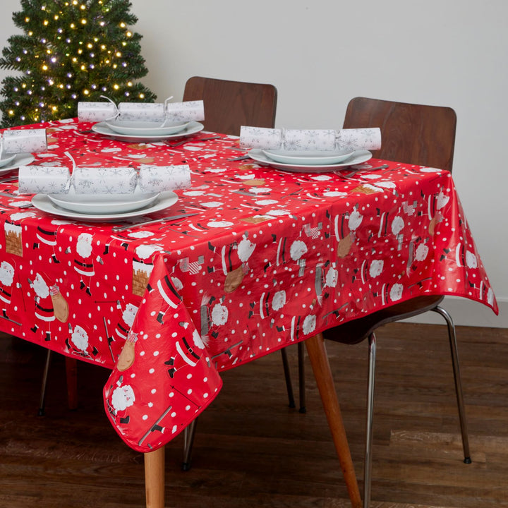 Two Christmas Designs PVC Tablecloths enhancing a beautifully set holiday table.