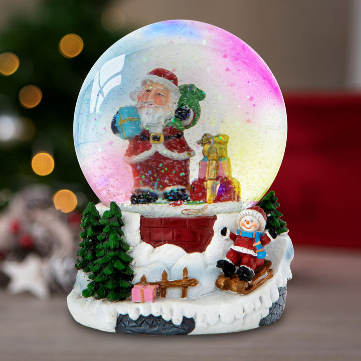 A mesmerizing water spinner snowglobe depicting a charming winter scene, where Santa and a child sled down snowy hills under the soft glow of LED lights.