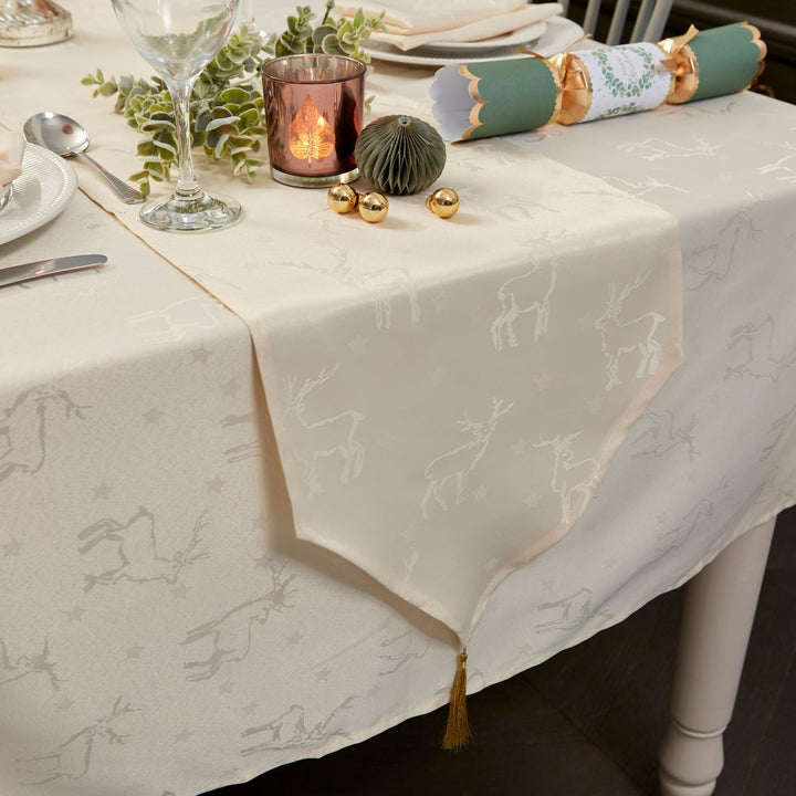 Cream-colored table runner with elegant deer designs, adding a touch of sophistication to your Christmas dinner by Celebright.