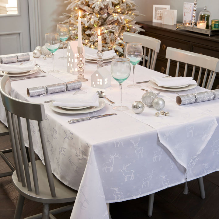 White tablecloth adorned with festive deer illustrations, creating a joyful atmosphere for your Christmas dinner by Celebright.