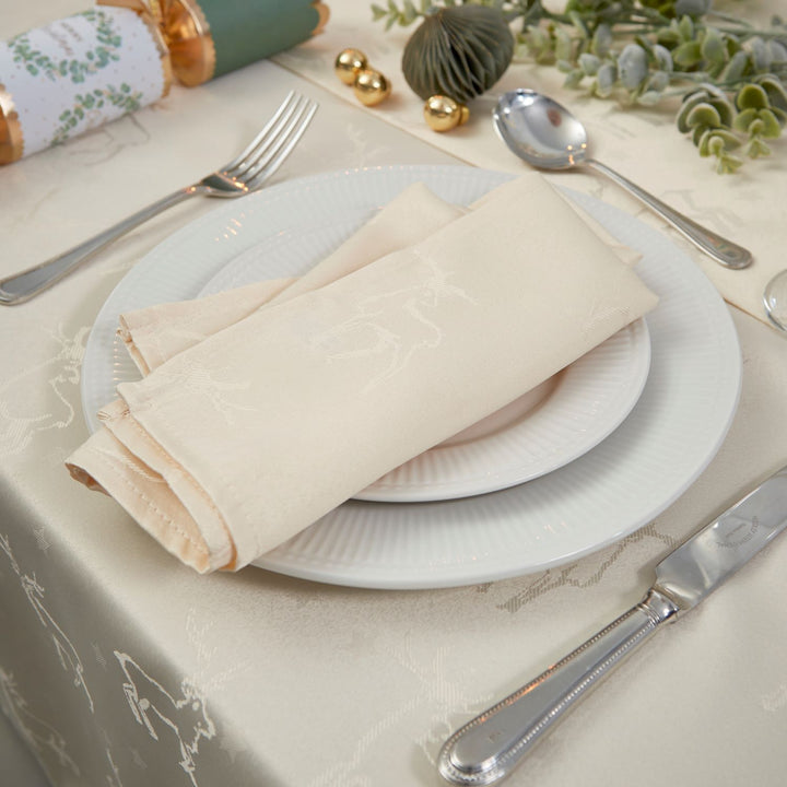 Set of cream napkins featuring elegant deer patterns, perfect for enhancing your dining table decor.