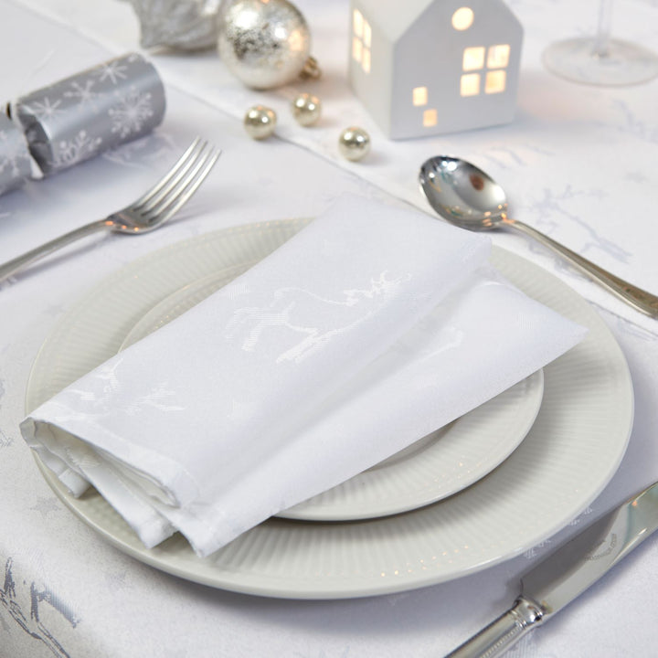 Set of white napkins showcasing exquisite deer motifs, perfect for adding sophistication to your table setting.