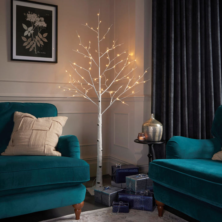 A stunning 6-foot white birch twig tree illuminated in warm white lights, adding a touch of elegance to any space.
