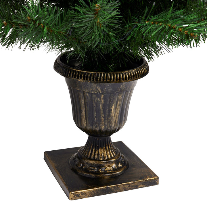 Adorned with lights, these 3ft Christmas trees stand gracefully in decorative pots, casting a soft glow, evoking the spirit of joy and celebration.
