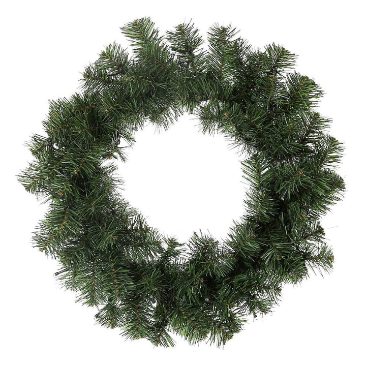 Close-up of a pre-lit Christmas wreath, garland, and two pre-lit 3ft pine trees, perfect for holiday decorating.