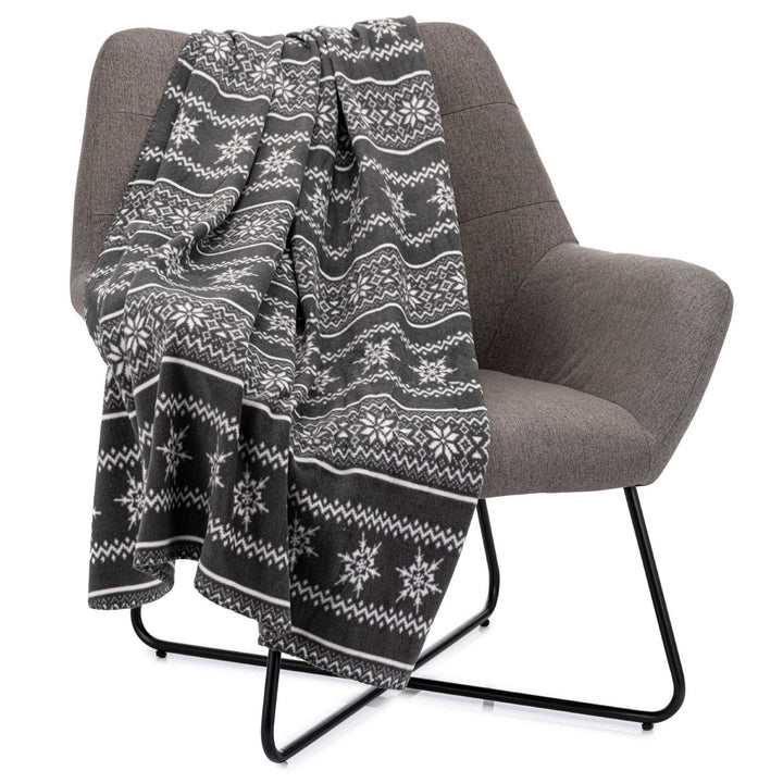 A soft, gray fleece throw blanket with a Scandi Nordic pattern, perfect for staying warm and stylish during the holidays.