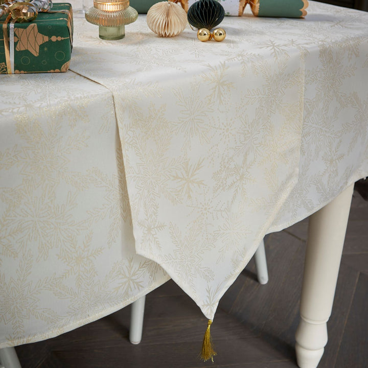 Elegantly set dinner table with a 13x72 inches metallic snowflake table runner.
