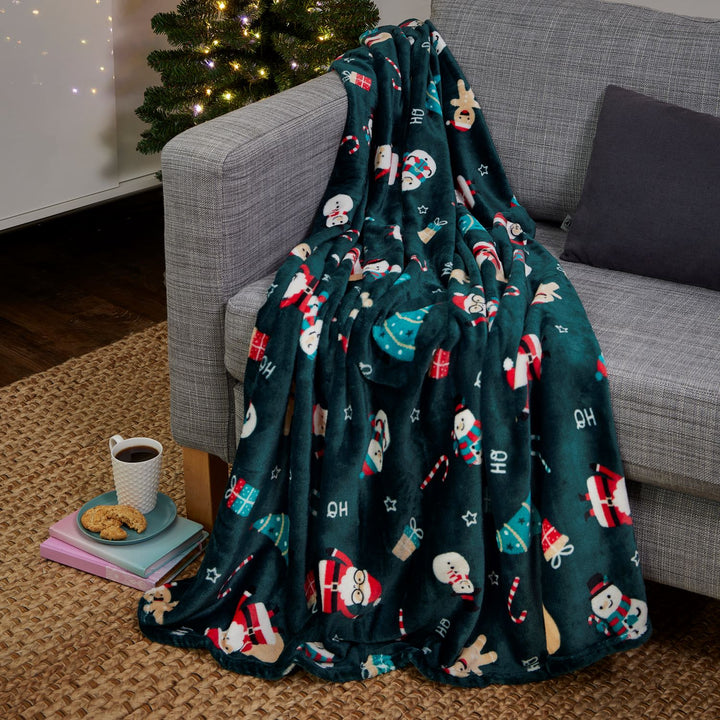 Sustainable fleece blanket with holiday motifs. 50x60in, 100% recycled material, perfect for festive warmth.