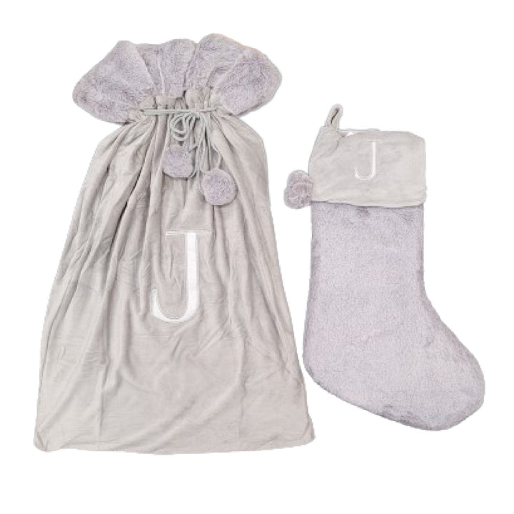 High-quality light grey stockings featuring a Monogrammed Letter J, perfect for elegant holiday decor. These luxurious sacks add a personalized touch to your festive celebrations.