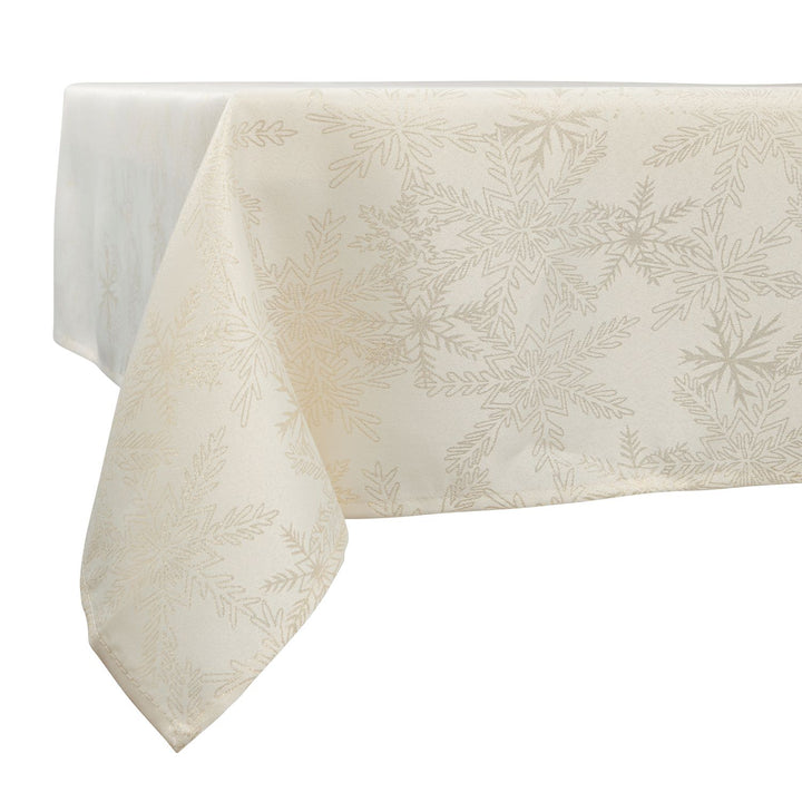 A stylish table setting featuring cream and gold metallic snowflake linens.