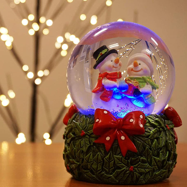 Enjoy the soothing melody and winter magic of the Mr & Mrs Snowman Musical Snow Globe.