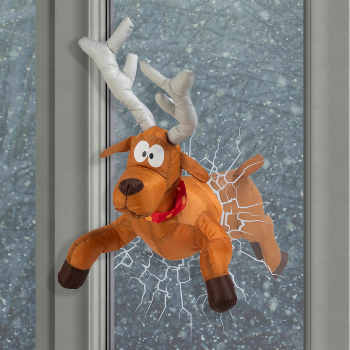 A holiday-themed window display with animated reindeer decorations.