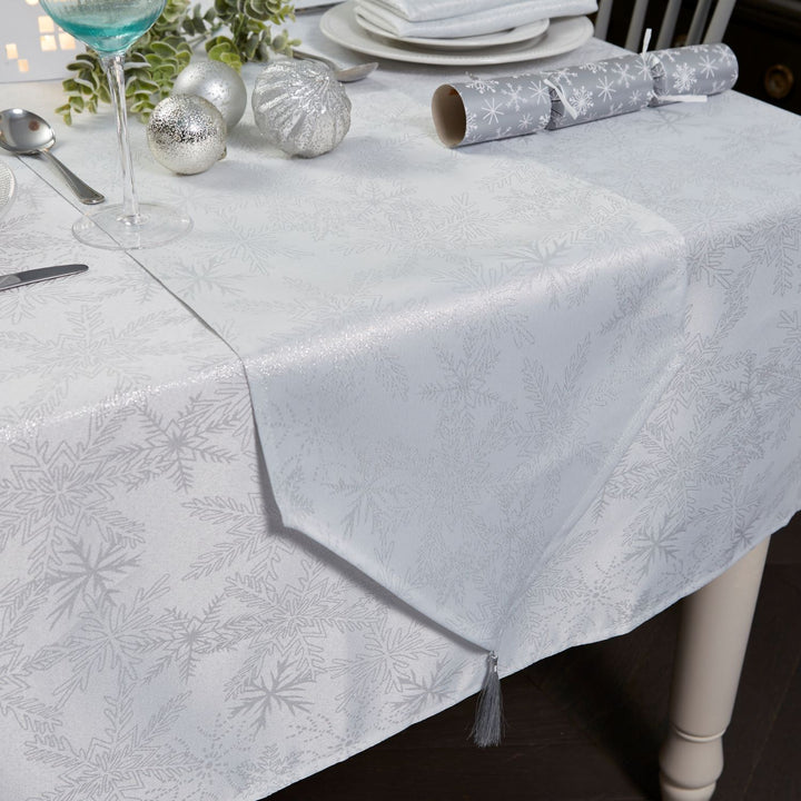 Festive dining setup with a 13x96 inches white and silver snowflake table runner.