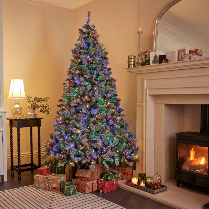 A 7ft snowy Windsor Christmas tree glowing warmly with 900 micro LED lights, bringing festive cheer to your home.