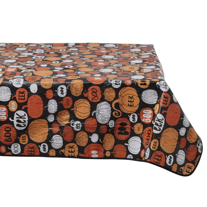 Dress your table in eerie style with PVC tablecloths adorned with haunted houses and witches for Halloween.
