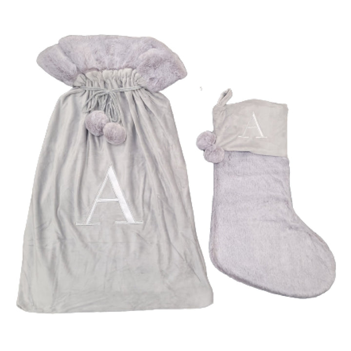 Elegant light grey stockings featuring a Monogrammed Letter A, enhancing your holiday ambiance with personalized sophistication. These luxurious sacks are a perfect blend of style and festive charm.
