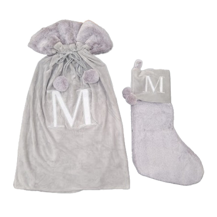 Classy light grey stockings adorned with a Monogrammed Letter M, perfect for adding a touch of personal elegance to your holiday festivities. These high-quality sacks are both stylish and festive.