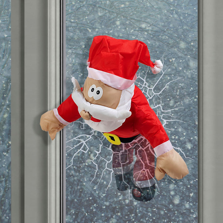 Magical animated Santa Claus decorations in motion for a holiday window display.