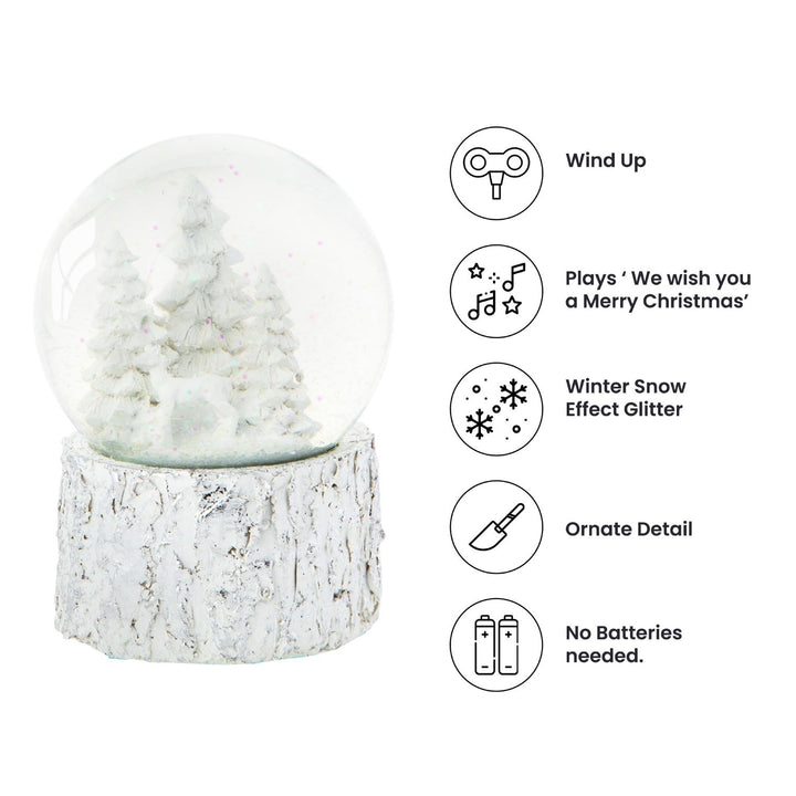 A charming musical snow globe featuring a serene scene with a white Christmas tree.