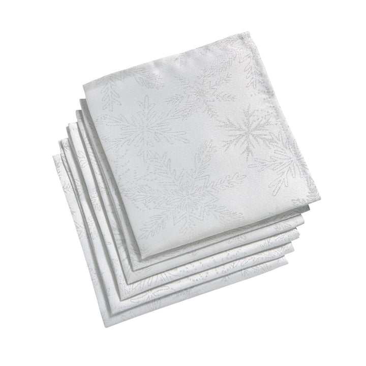 Six white and silver napkins adorned with delicate snowflake designs.