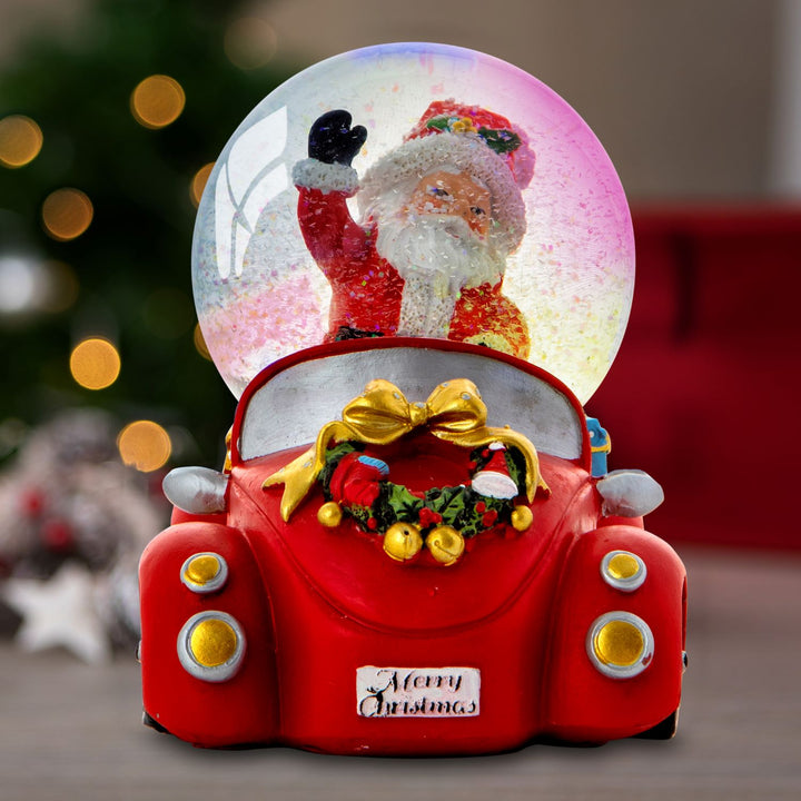Capture the spirit of the season with a Santa Claus in a car decoration inside a musical snow globe.