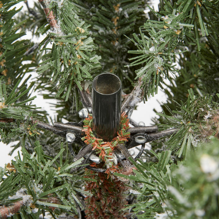 A 6ft tall Nordic Spruce Christmas tree covered in snow for a charming touch.