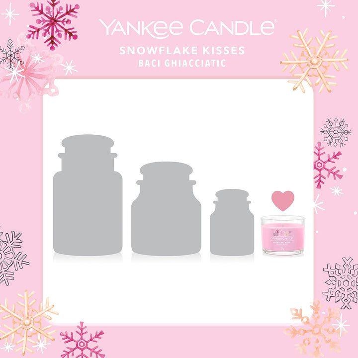 Set of three Snowflake Kisses Yankee Candle votives, releasing a delightful aroma of winter spices, with snowflake motifs, enhancing the holiday spirit.