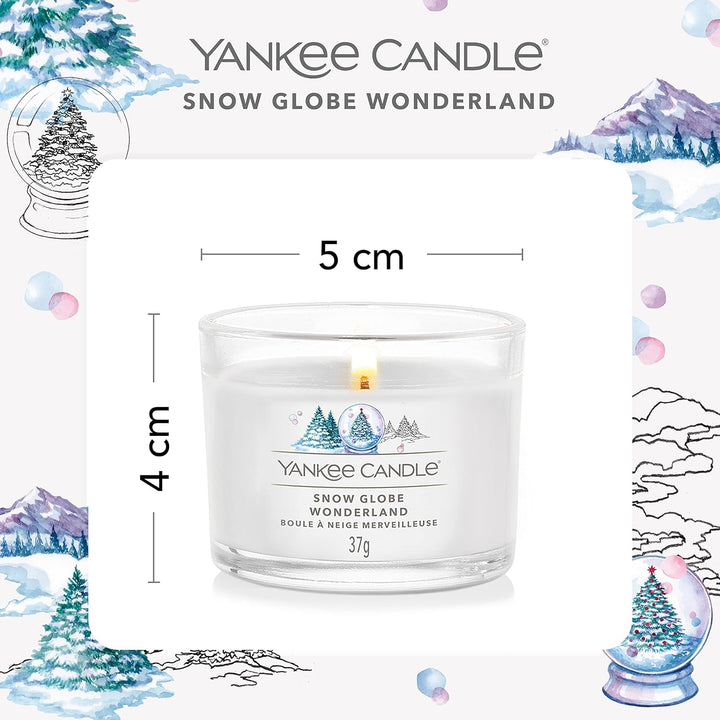 A collection of three Yankee Candle votives nestled in a snowy setting, radiating a sense of seasonal joy.