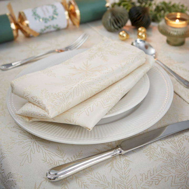 Sophisticated cream and gold table setting featuring a 52x70 inches tablecloth.