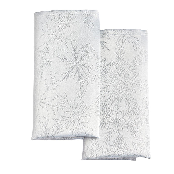 Special occasion napkin set with white and silver metallic snowflake patterns.
