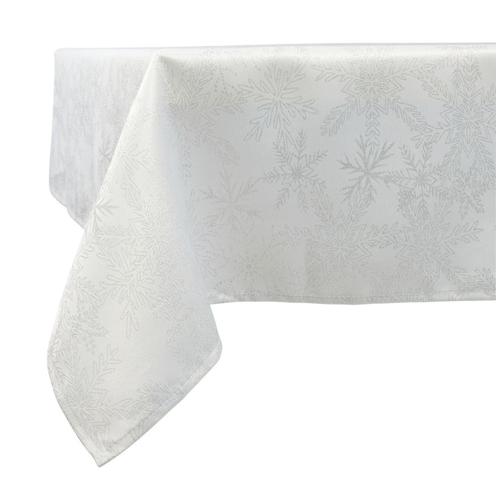 Stylish dining affair with a white and silver snowflake tablecloth measuring 52x70 inches.