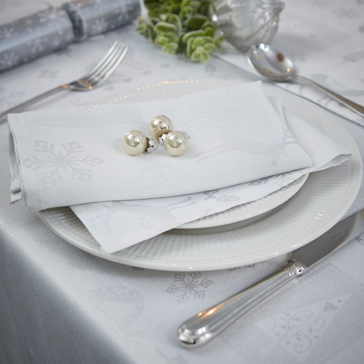 Stylish dining arrangement with Celebright's White/Silver Metallic Christmas napkins.