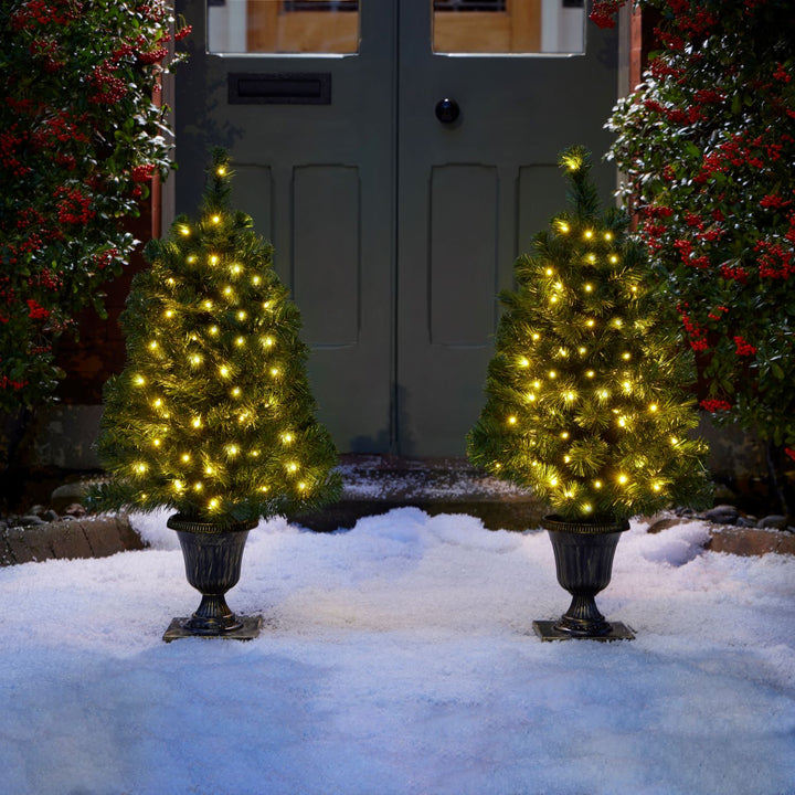 A delightful duo of 3ft Christmas trees illuminated with soft lights, elegantly displayed in decorative pots, adding a touch of magic to your holiday decor.