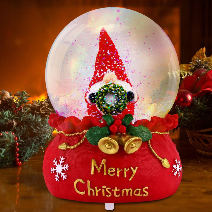 The Christmas Musical Snowglobe emitting a cozy glow from its LED lights, highlighting the joyful scene of Gonk and a Wreath.