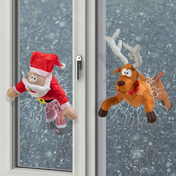 A charming holiday decoration featuring a whimsical scene of a crashing reindeer and Santa Claus figurines.