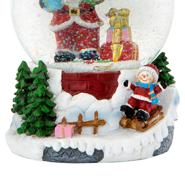 Add a touch of whimsy to your holiday decor with this Santa & Child Sledging snow globe.