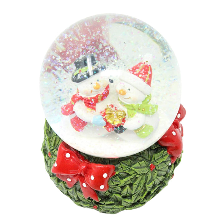 Let the whimsy of snowman love fill your heart with this musical snow globe.