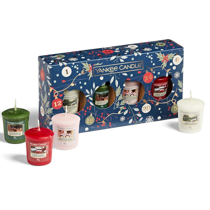 A Yankee Candle Christmas Festive 4 Votive Gift Set featuring warm, inviting scents that evoke the essence of a cozy holiday gathering.
